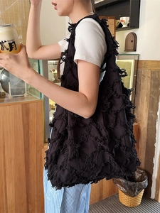 Black tassel canvas tote bag with textured fringe design for large capacity storage