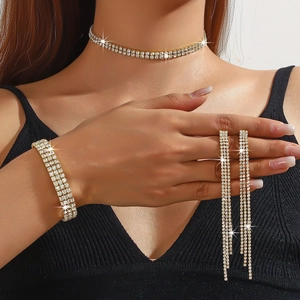 Detailed view of glamorous gold rhinestone jewelry set featuring choker, bracelet, and earrings