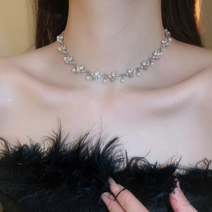 Elegant silver pearl necklace with sparkling crystals on model's neckline
