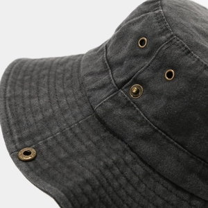 Detailed macro view of dark grey washed cotton sun hat with metal eyelets and stitching