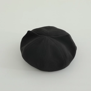 Top view detail of a black knitted beret for kids featuring cute 3D cat ear accents