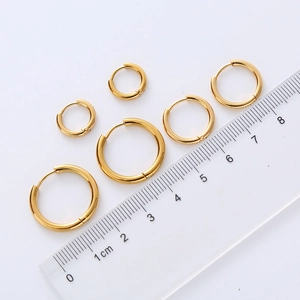 Set of 6 gold minimalist hoop earrings in various sizes shown with a measurement ruler