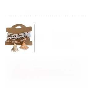 Detail view of multi-layer crystal beads bohemian bracelet with tassels on a size card
