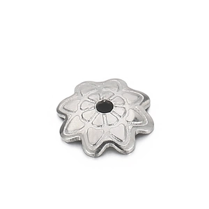 Macro shot of a silver 8-petal hollow flower bead cap with detailed floral texture