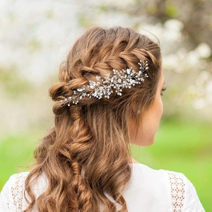 Detail of silver bridal hair vine with crystals and beads woven in a braided hairstyle