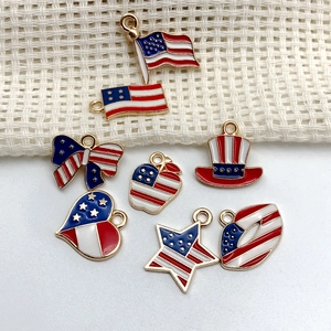 Detail of eight enamel USA flag pendants in various shapes with gold metal base