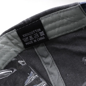 Detailed view of the 100% cotton inner lining and wash label of a baseball cap