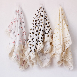 Three-pack cotton gauze baby blankets with tassels featuring floral, leopard, and leaf prints
