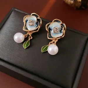 Vintage floral pearl drop earrings with blue enamel petals and sparkling rhinestone center