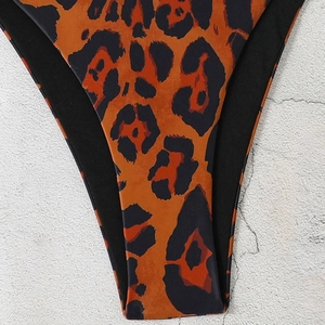 Leopard print triangle bikini bottom with black trim and high cut leg for beachwear