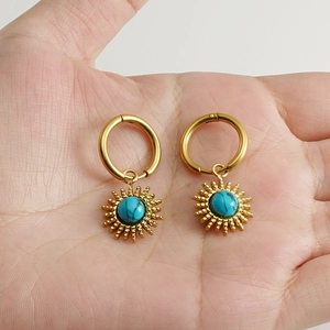 Bohemian gold hoop earrings with sunburst charms and blue turquoise center stones