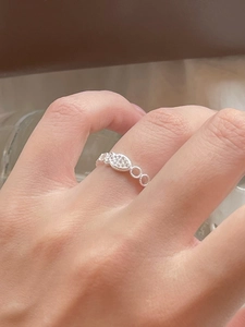 Detailed close-up of 925 silver marquise-shaped ring with pavé zircons on finger