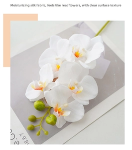 Close-up of artificial white orchid with realistic texture and moisturizing fabric petals
