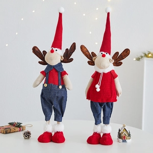 Christmas reindeer dolls in red sweaters and pointed hats for festive table decoration