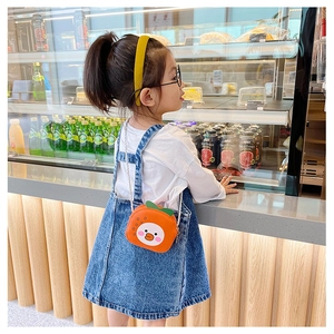 Detail of cute orange animal crossbody bag for little girls in a cozy lifestyle setting