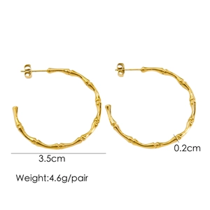 Macro detail of gold bamboo-style hoop earrings with 3.5cm diameter and weight specs