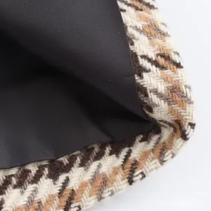 Macro shot of French style houndstooth coat fabric with premium black inner lining texture