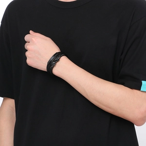 Men's multi-layer leather braided bracelet with skull magnetic clasp on a male wrist