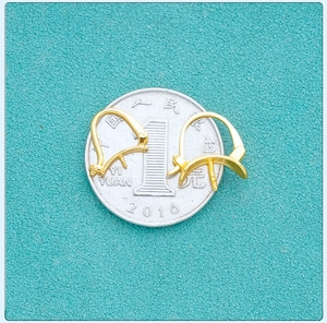 Size comparison of gold-plated S925 silver earring hooks placed on a one-yuan coin