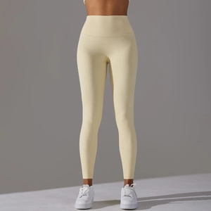 Detail of high-waist seamless yoga leggings in cream color with body-shaping fit