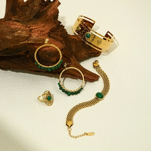 Detailed view of 18k gold plated jewelry set with green malachite stones and hammered texture