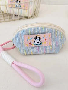 Cute cream-colored headphone pouch with blue stripes and dalmatian pattern decoration