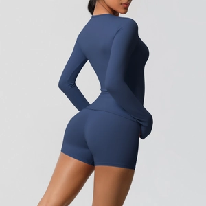 Detail view showing fit of navy blue long sleeve yoga top and tight sports shorts