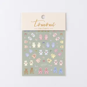 Detail of 5D embossed nail stickers featuring cute cartoon bears and colorful bubbles