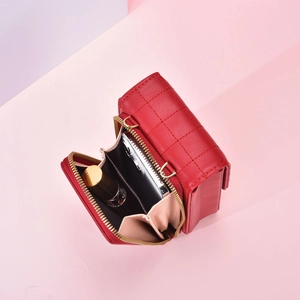 Red quilted small crossbody bag with 45-degree interior view showing organized compartments