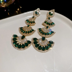 Detailed close-up of emerald drop fringe necklace with sparkling diamond accents