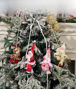 Detailed view of four colorful Santa Claus figurines climbing ropes for tree decoration