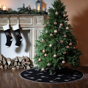 Black knit Christmas tree skirt and stocking set with white snowflakes and candy canes