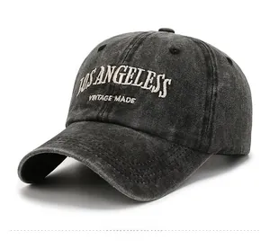 Detail of vintage washed black baseball cap featuring Los Angeles embroidery and cotton texture