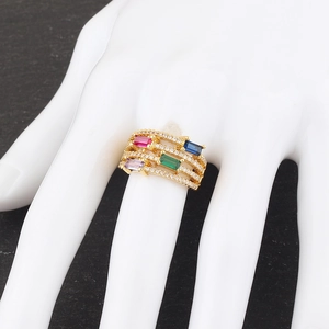 Detail of gold stacked ring with multi-color rectangular gems and pave crystal accents