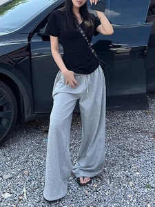 Slim fit black V-neck short sleeve T-shirt for women styled with casual gray joggers
