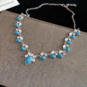 Bohemian silver necklace with turquoise teardrop pendant and white decorative stones