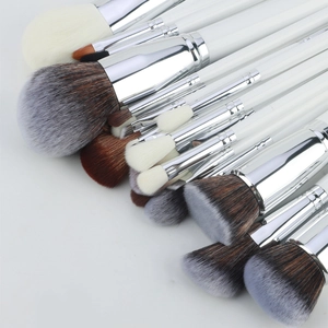Detailed overhead view of 30pcs professional makeup brushes with silver ferrules