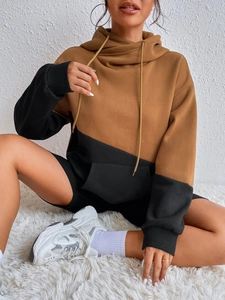 Detail of color-block hoodie with brown and black panels and large front pocket