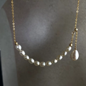 Detailed view of natural pearls on a 14K gold-filled adjustable necklace chain