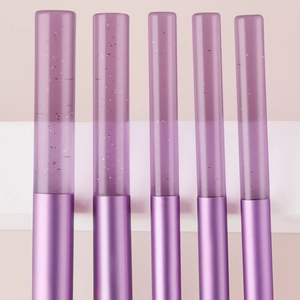 Macro shot of purple crystal handles with glitter for 5-piece makeup brush set