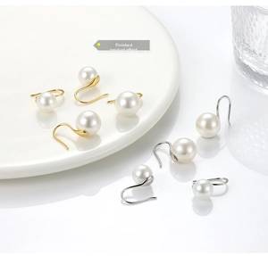 Detail of S925 sterling silver pearl hook earrings in gold and silver finishes
