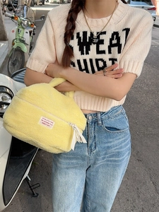Large capacity yellow plush cosmetic bag for travel and skincare storage with handle