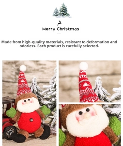 Close-up of plush Christmas dolls with knitted hats and festive decorations on tree