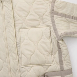 Women's quilted stand collar jacket with wave stitching and large patch pockets in beige