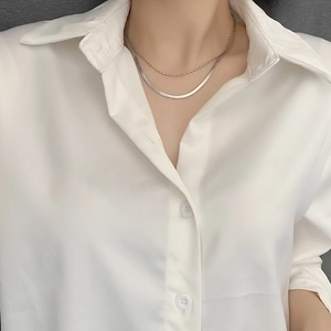 Minimalist double layer silver snake bone chain necklace worn with a white shirt