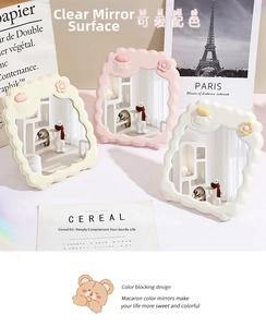 Detailed view of cloud-shaped desktop makeup mirrors in creamy yellow and pink colors