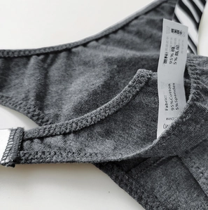 Detail of the cotton thong fabric and care label showing 95% cotton material