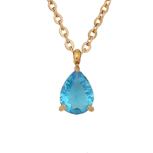 Gold necklace with a pear-cut blue gemstone pendant on a clean white background