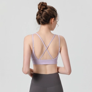 High-impact sports bra in lavender with criss-cross back straps and grey yoga pants