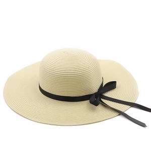 Women's wide brim straw sun hat with black bow, perfect for summer beach vacation